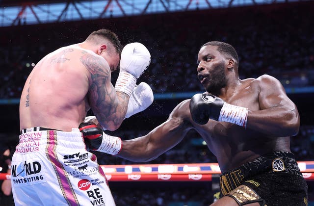 <p>Okolie (right) goes to the body of Lerena</p>