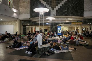 People take shelter inside a metro station during a Russian drone strike in Kyiv