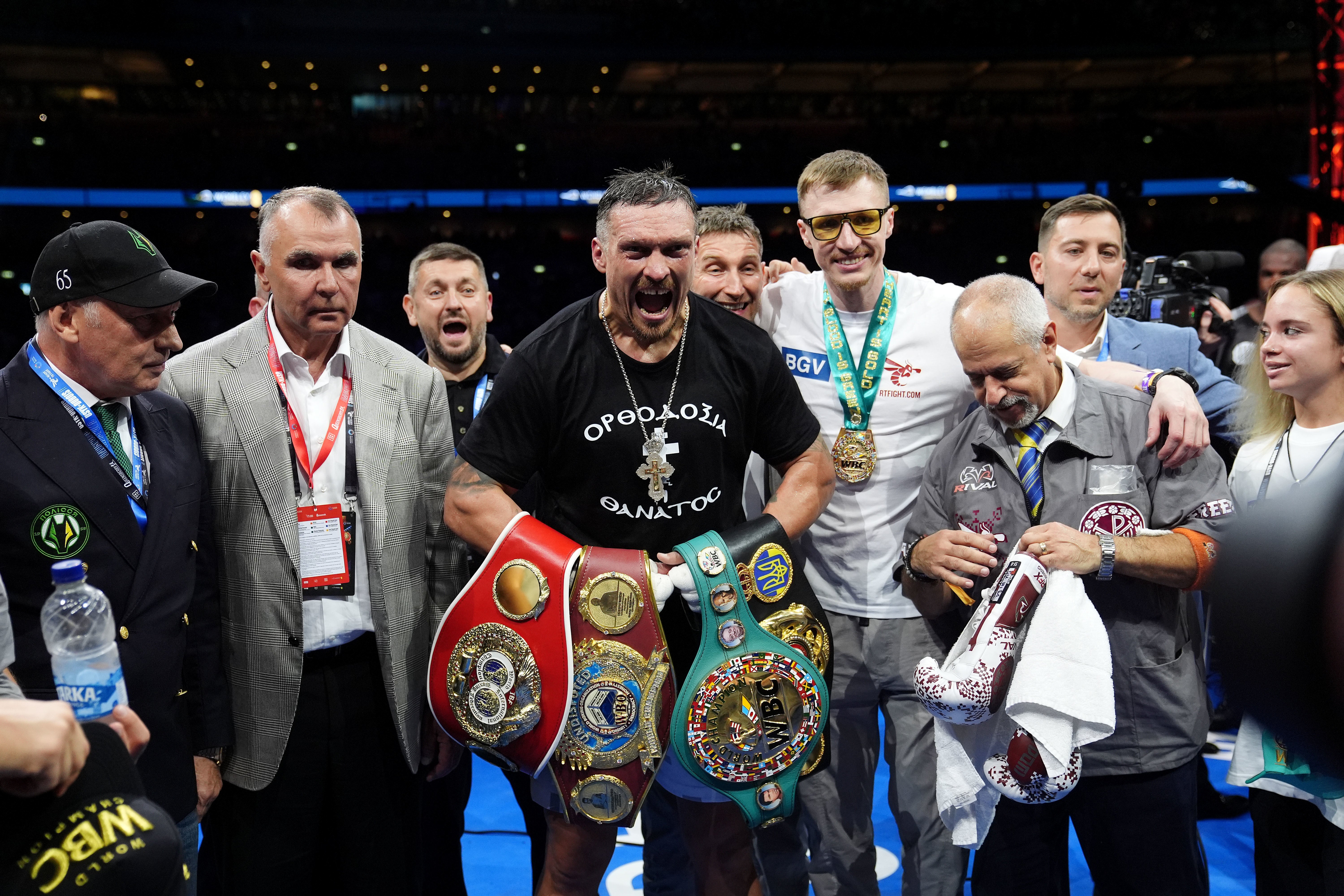 Oleksandr Usyk celebrates winning the IBF, IBO, WBC and WBO world heavyweight bout against Daniel Dubois at Wembley Stadium (Bradley Collyer/PA)
