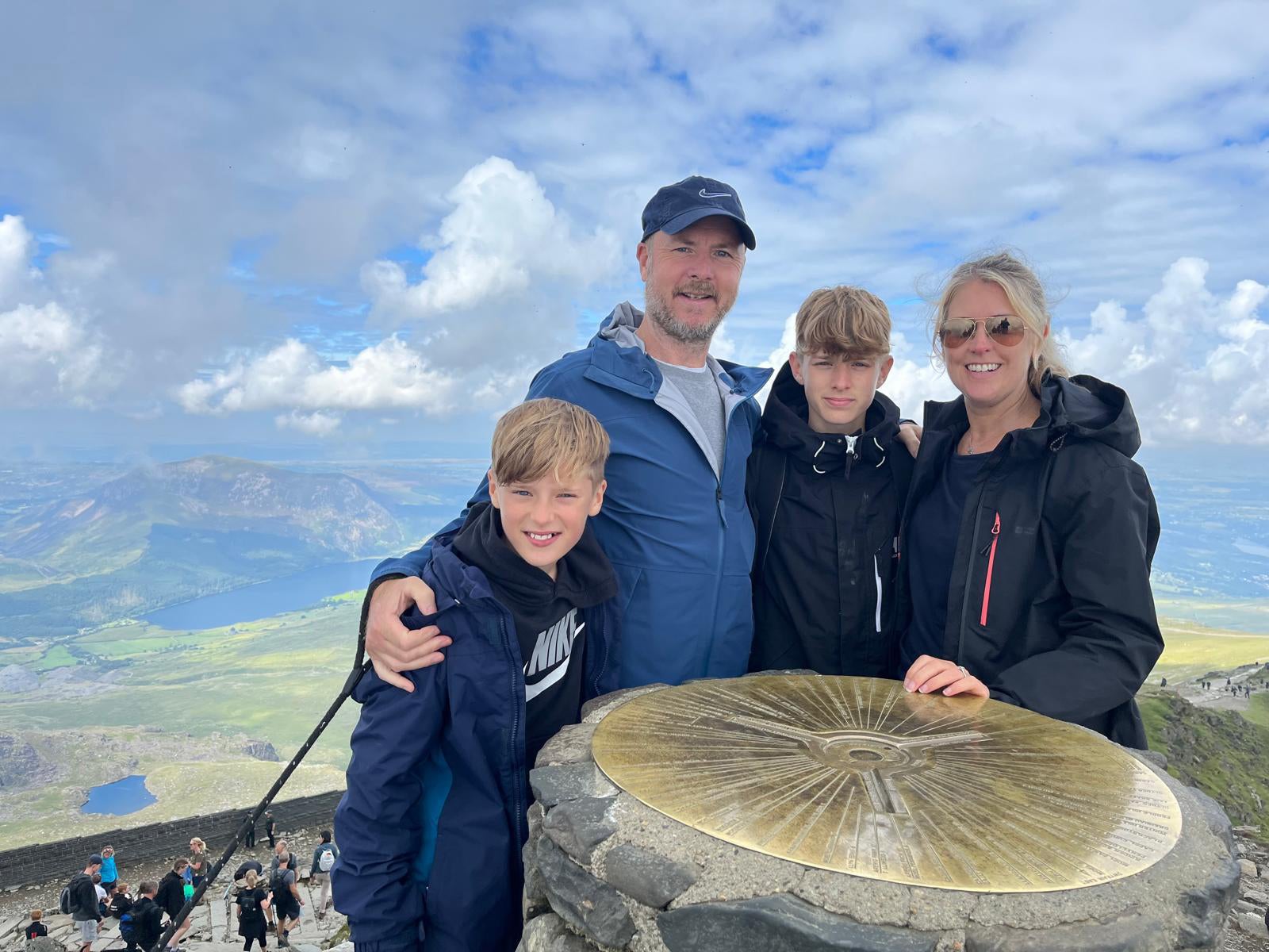 Jamie (left) with his parents, Adam and Sam, and his brother Harry