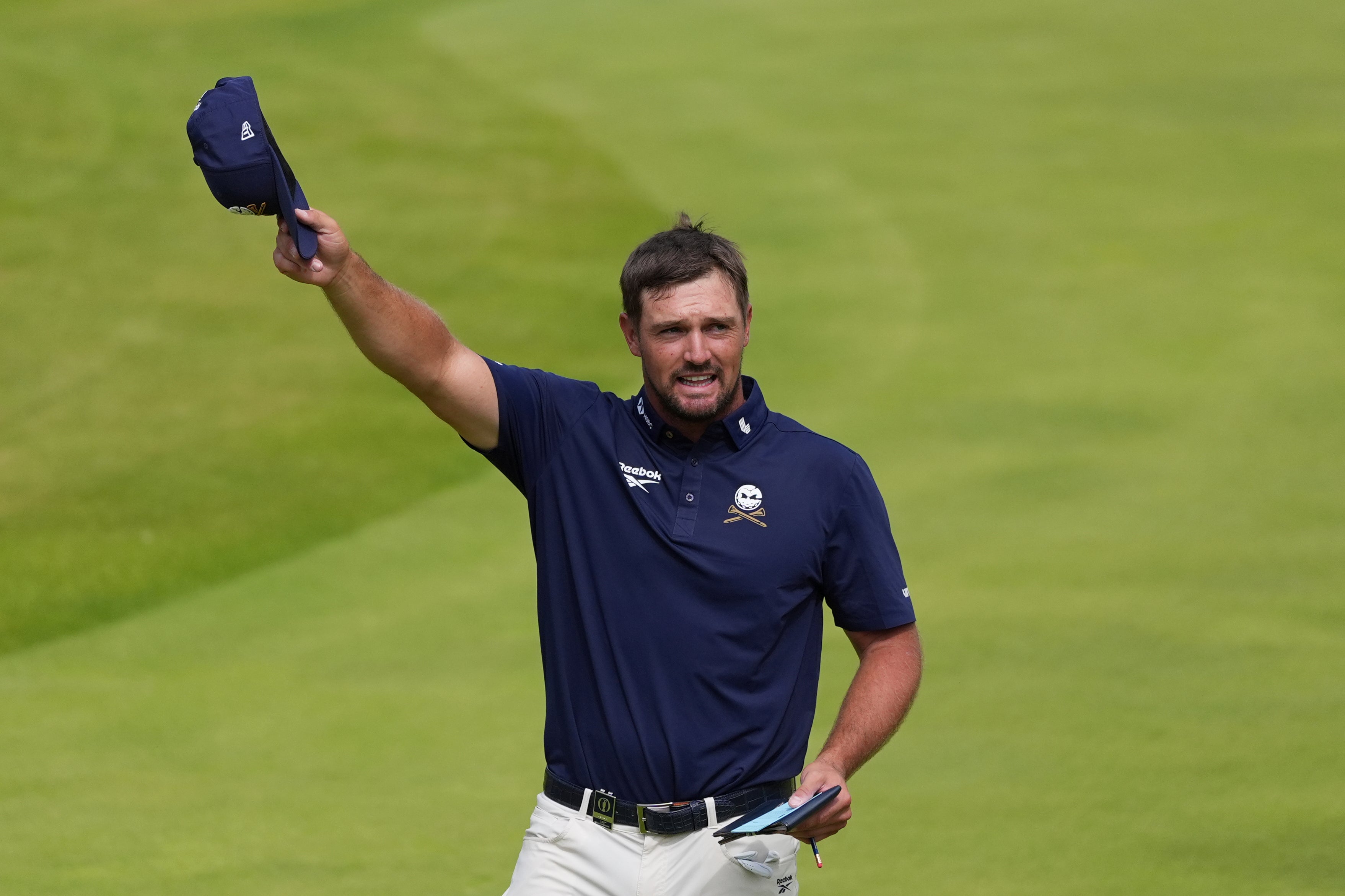 Bryson DeChambeau of the United States reacts after he putts on the 18th green