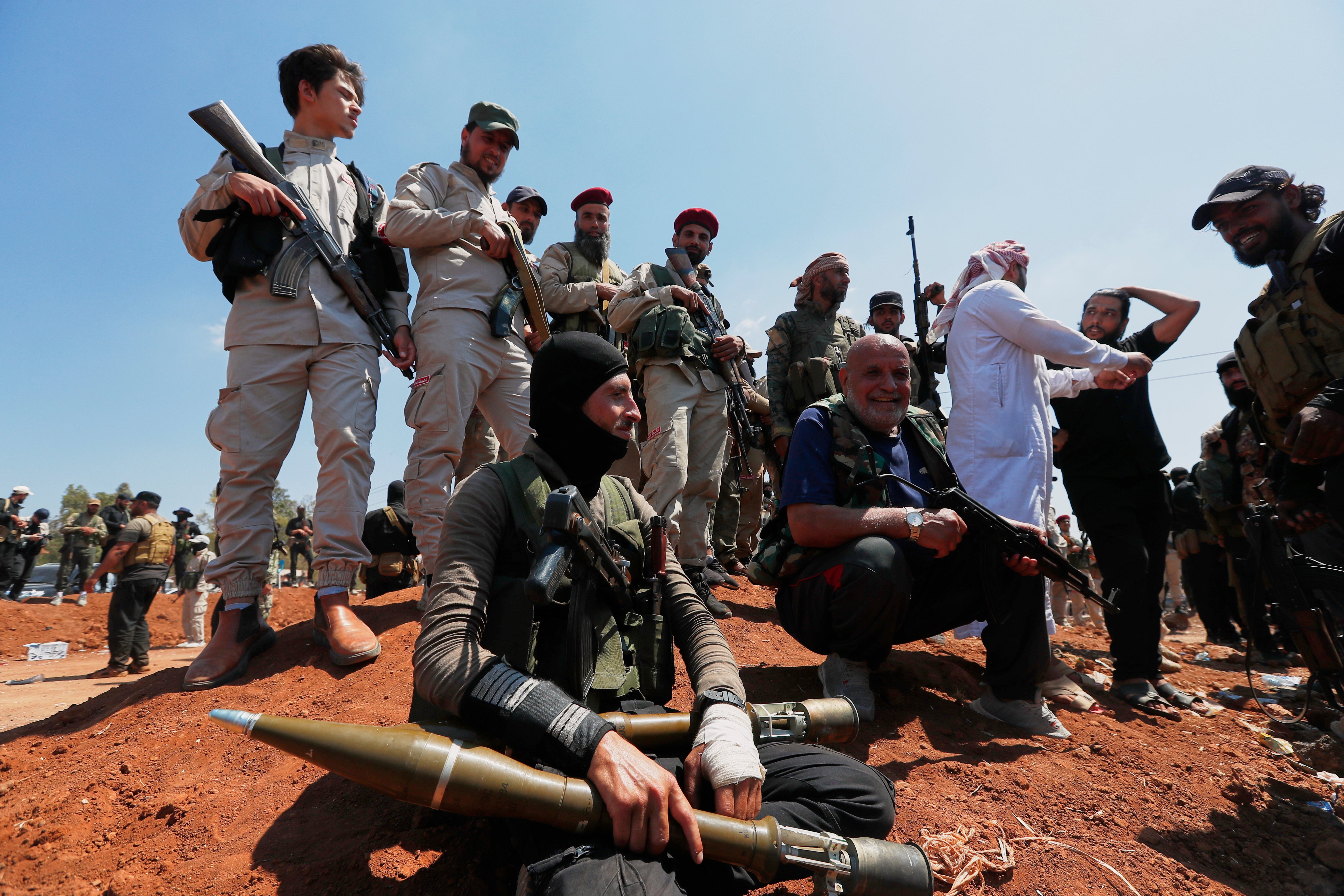 Bedouin fighters gather as Syrian government security forces block them from entering Sweida province, in Busra al-Harir village