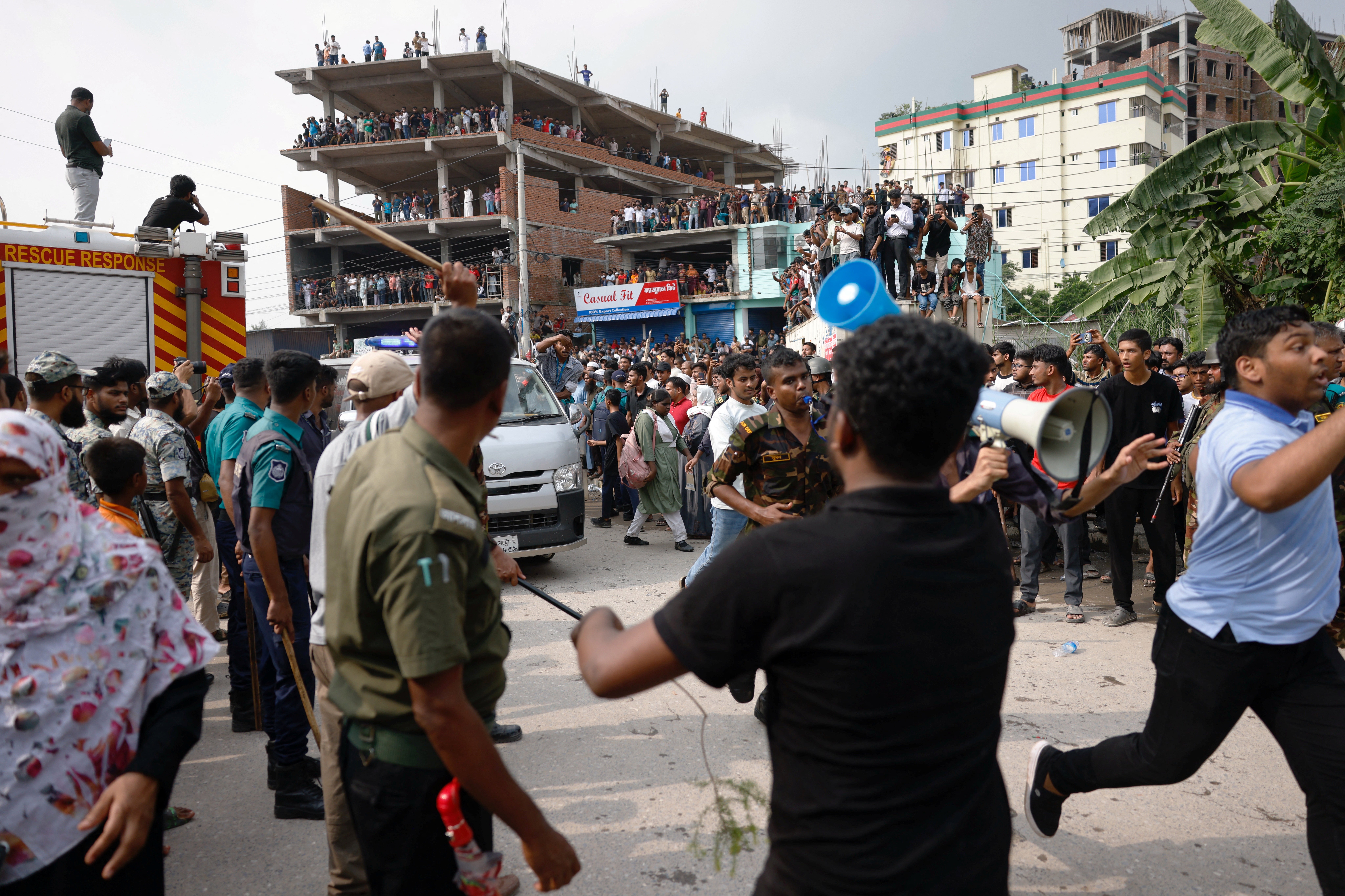 <p>An ambulance carrying injured people after an air force training aircraft crashed into Milestone College campus, in Dhaka</p>