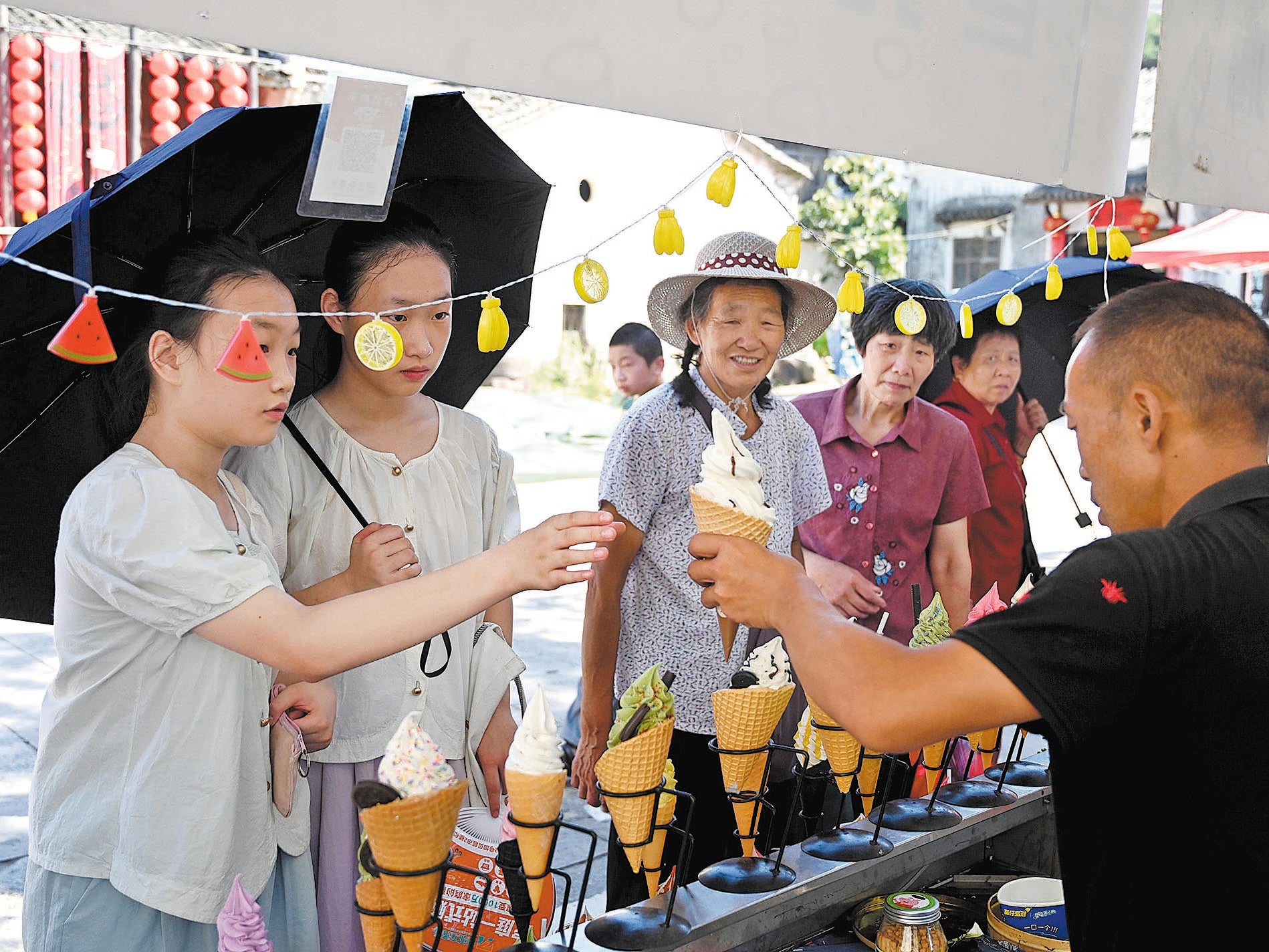 Tourists select ice cream at an ancient village-style snack stand in Jinhua, Zhejiang province