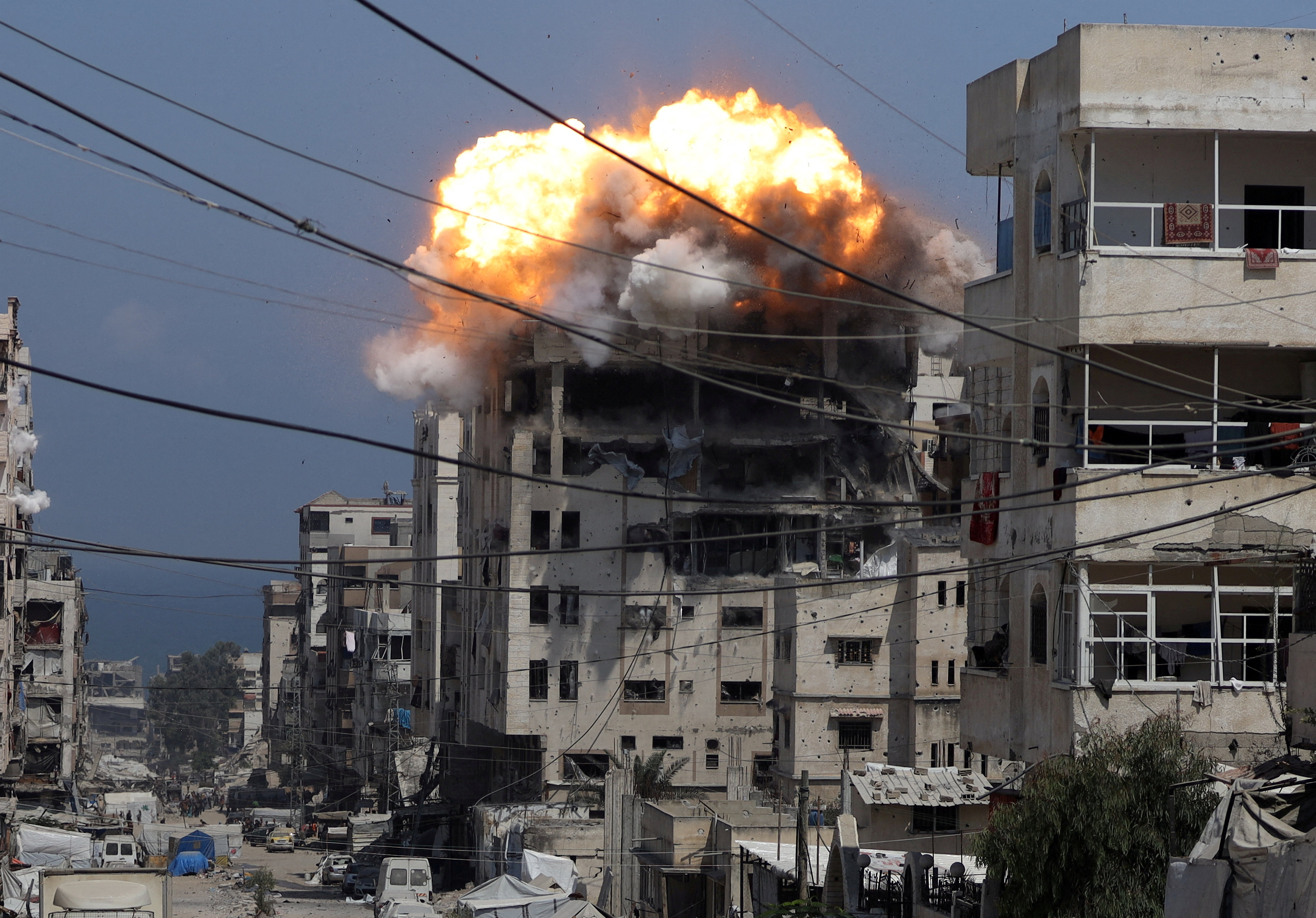 Smoke and flames rise from a residential building hit by an Israeli strike, in Gaza City