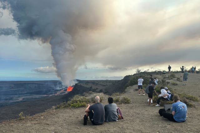 <p>People watch the Kilauea volcano on Hawaii's Big Island as it erupts on Sunday, July 20, 2025</p>