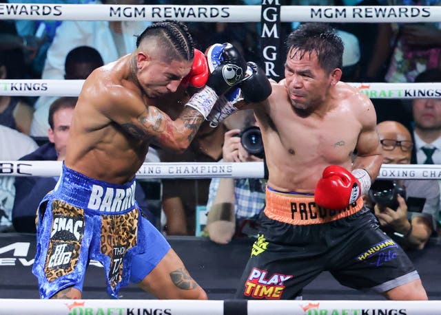 <p>Manny Pacquiao (right) during his title challenge against Mario Barrios</p>