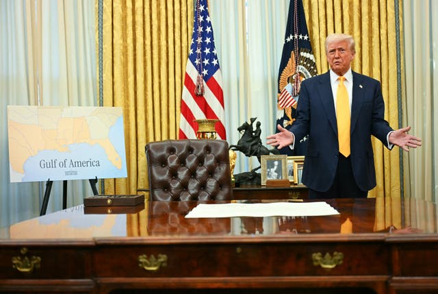 <p>President Donald Trump stands next to a 'Gulf of America' poster</p>