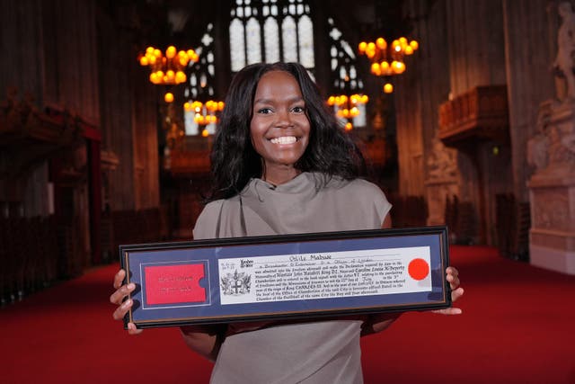 Oti Mabuse poses for photos in the Great Hall, after receiving the Freedom of the City of London at the Guildhall, London (Yui Mok/PA)