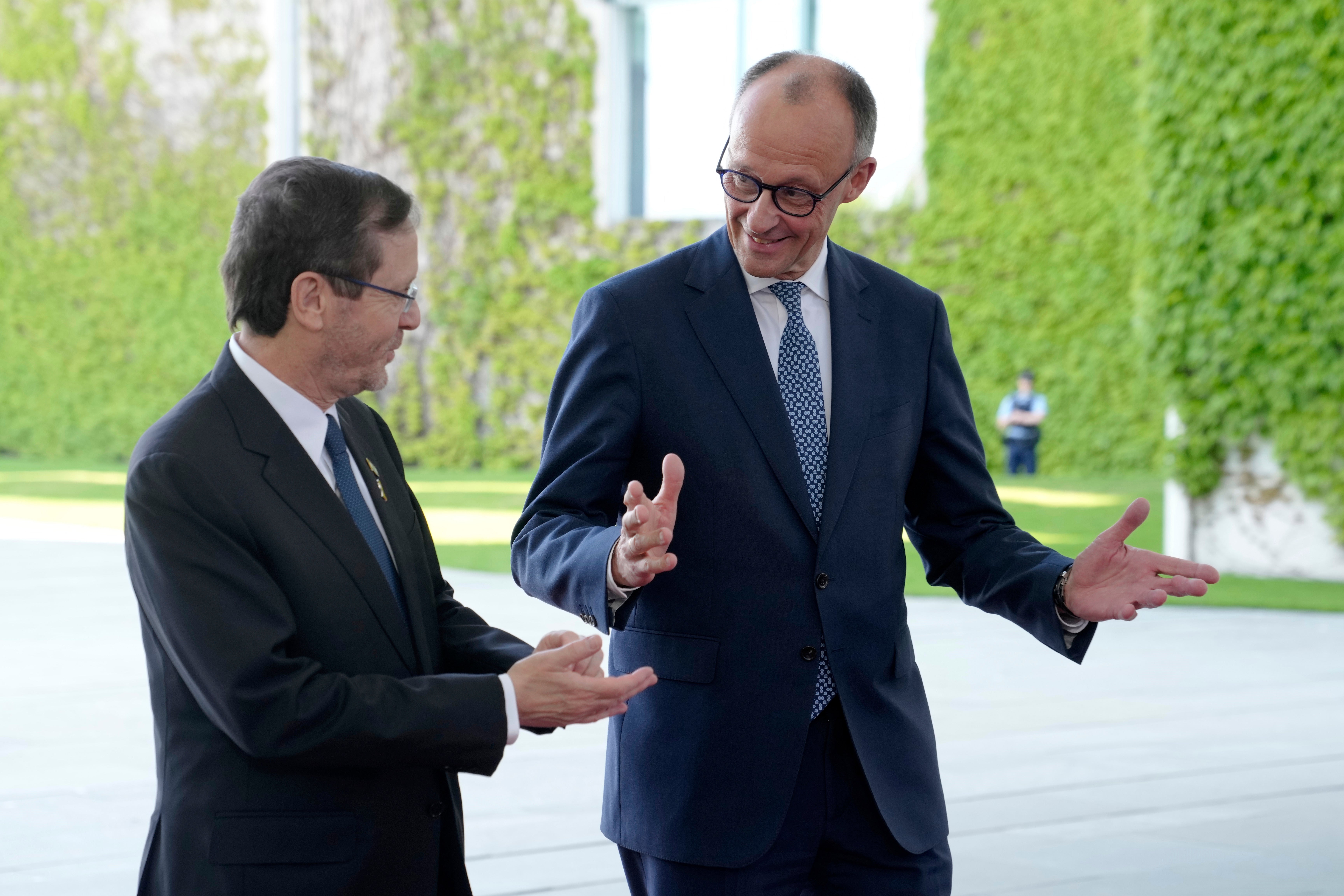 German Chancellor Friedrich Merz, right, welcomes Israeli President Isaac Herzog for a meeting at the chancellery in Berlin, Germany, on May 12, 2025