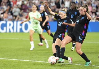 Chloe Kelly, centre, wins the race to score England’s winner after having her penalty saved (Nick Potts/PA)