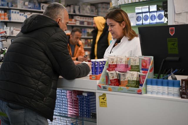 <p>Representational. A pharmacy owner speaks with a customer at a pharmacy in Pristina </p>