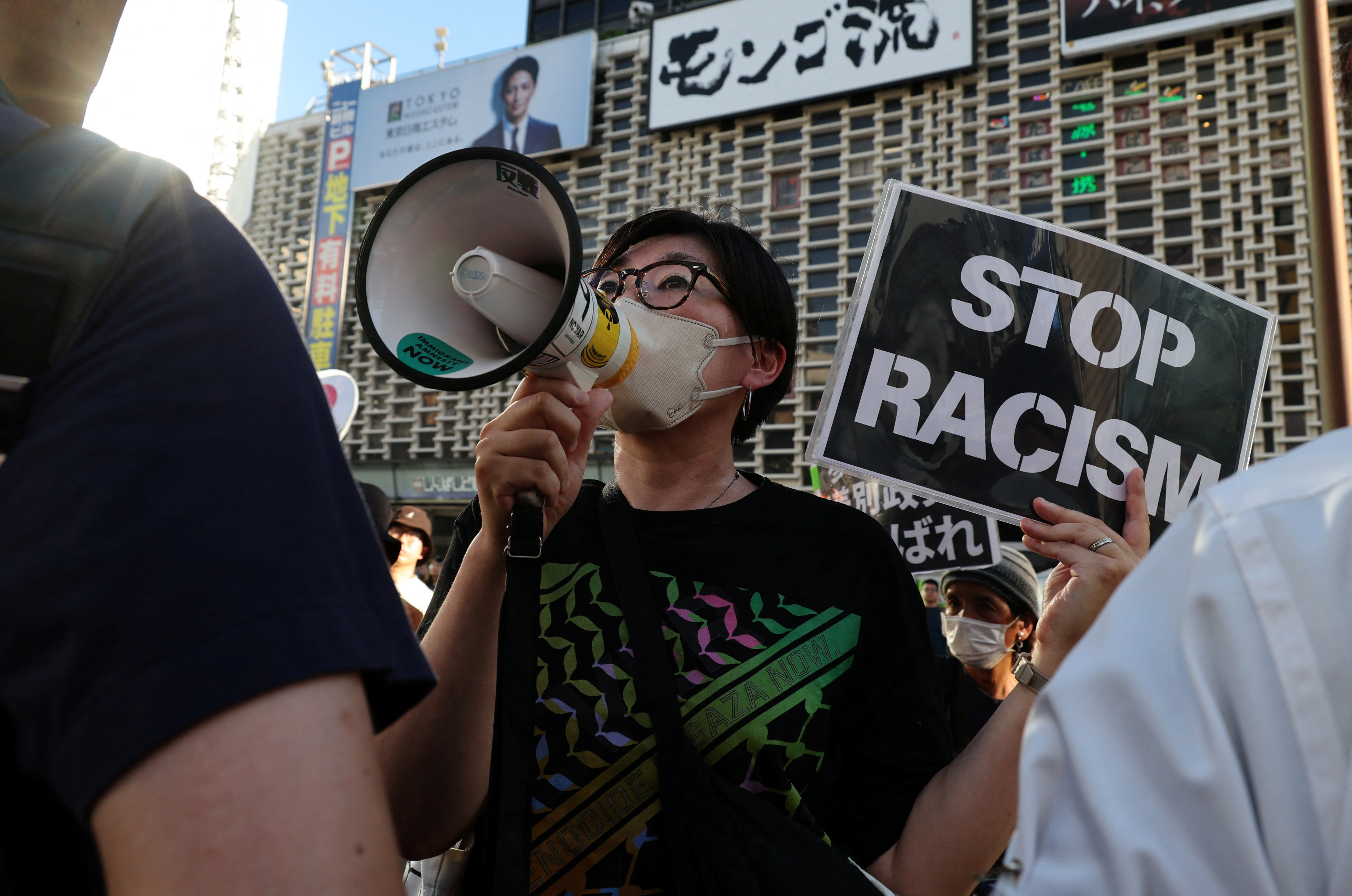 A woman protesting against Sanseito shouts slogans as the party holds a rally in Tokyo on 21 July 2025