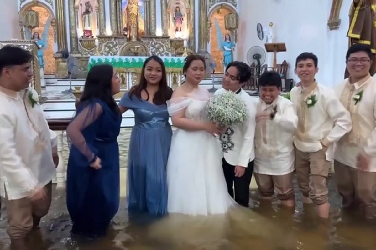 Philippines couple refuse to let flooded church dampen wedding day