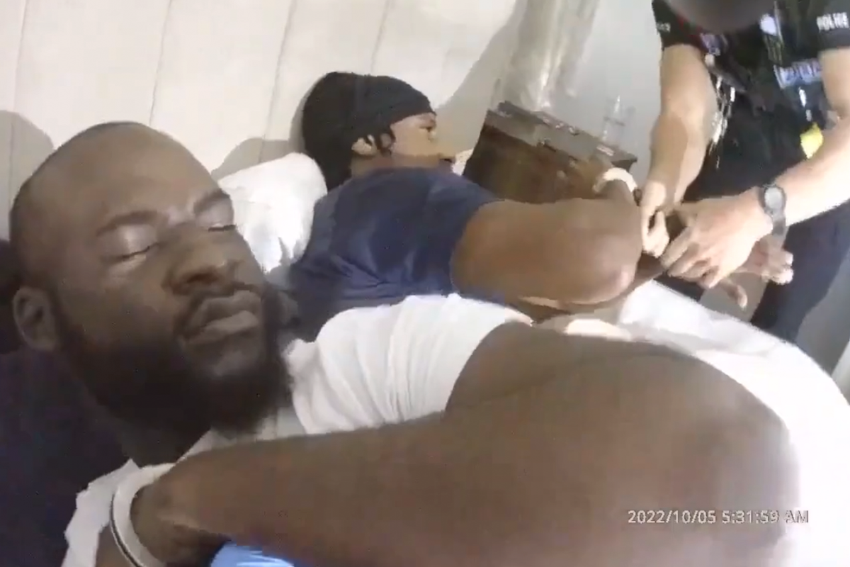 Moment police handcuff bleary-eyed drug dealers sleeping in bed