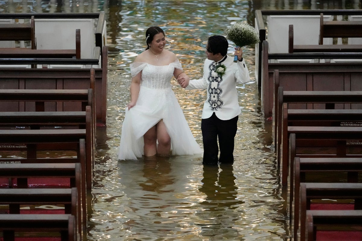 Couple wades through knee-deep water to marry in flooded church as Typhoon Wipha lashes Philippines: ‘It’s a test’