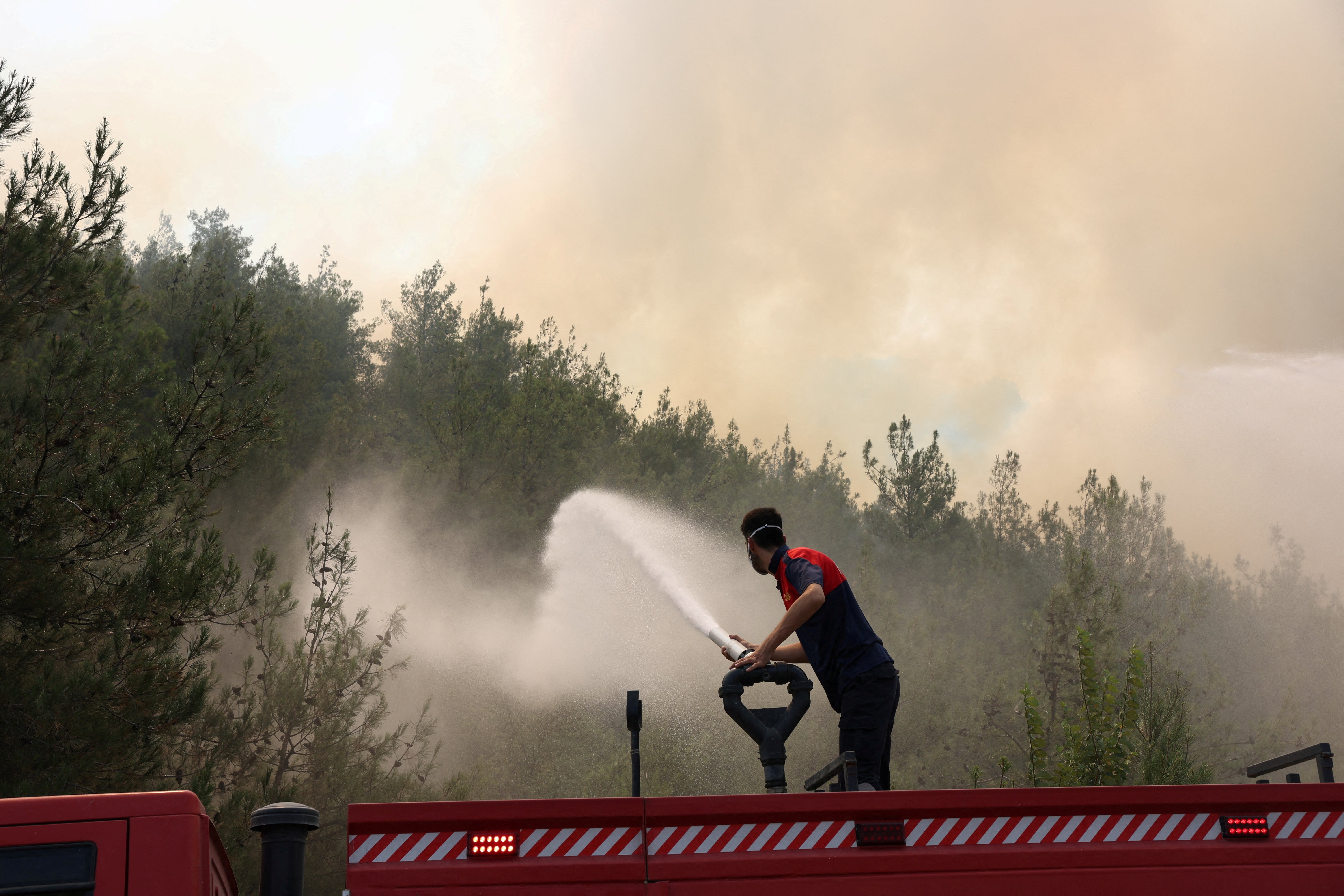 A firefighter responds to a wildfire near Osmaneli in the western Bilecik province, Turkey, 24 July