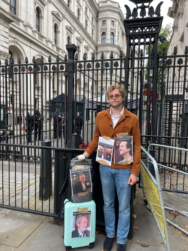 <p>Alois Christian Michel, 27, protests outside Downing Street on Thursday over the detention of his father Christian Michel in India</p>