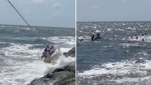 Ten people rescued after sailboat hits rocks on Jersey shore