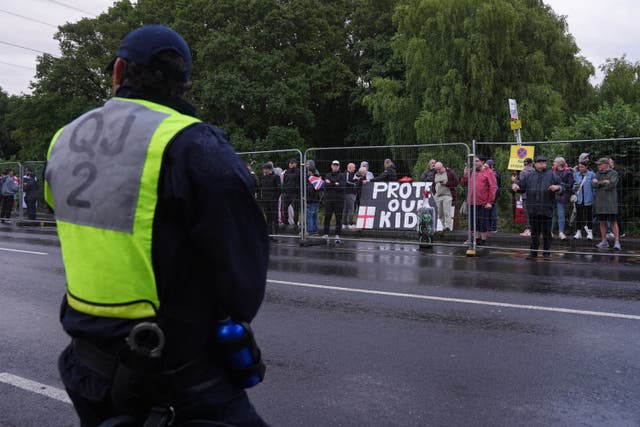 <p>Protesters and police outside the Bell Hotel in Epping that is believed to be housing asylum seekers</p>
