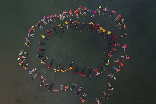 Life-saving organisations and emergency services joined to make a Circle of Life at Cullercoats Bay, North Tyneside, to highlight the Float to Live technique (Owen Humphreys/PA)