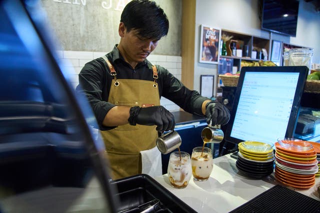<p>An employee prepares a coffee for a customer at Himalayan Java cafe at Boudhanath Stupa in Kathmandu, Nepal, Tuesday, June 10, 2025. (AP Photo/Niranjan Shrestha)</p>