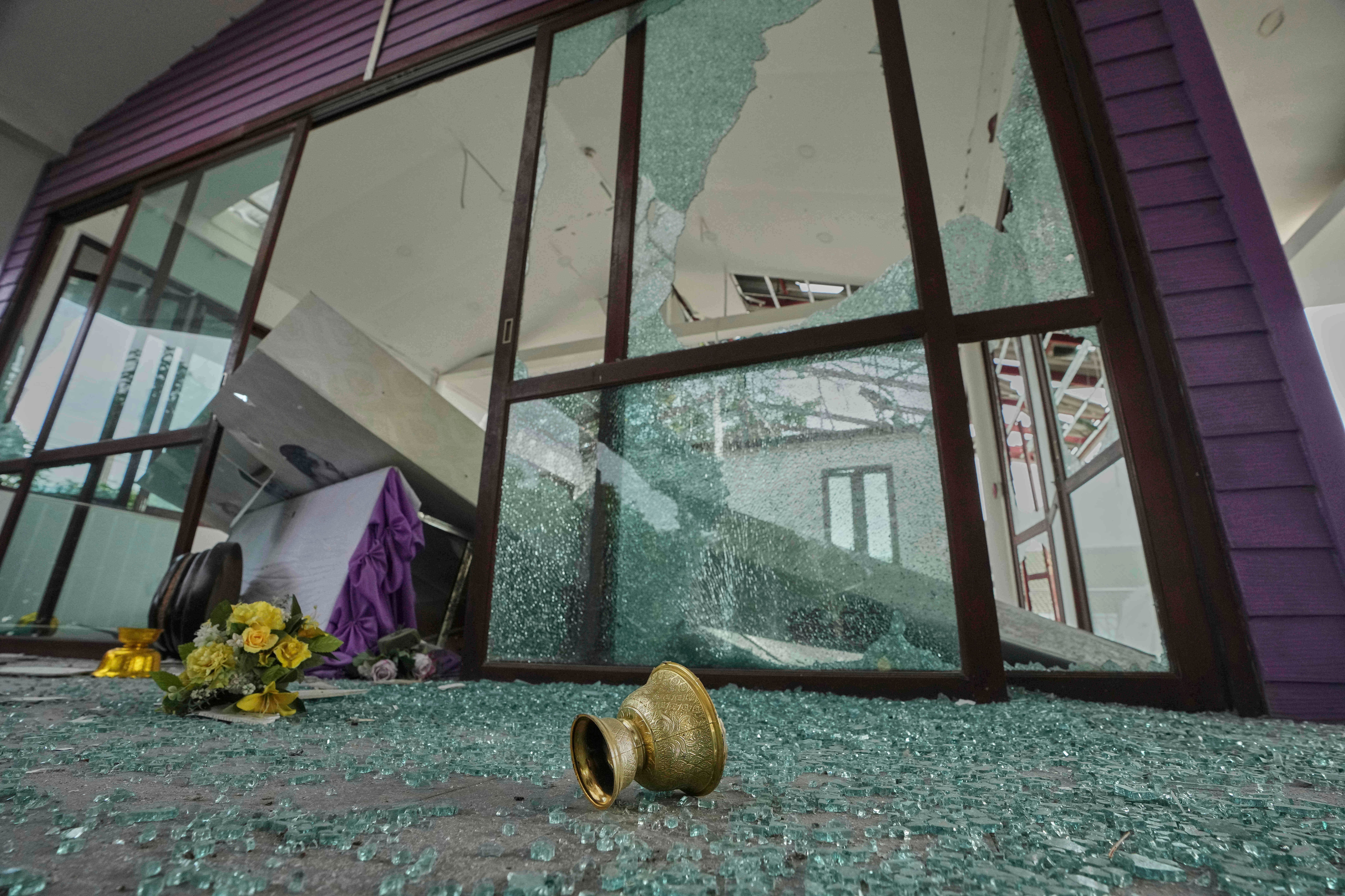 A door of the Phanom Dong Rak hospital is left damaged by Cambodia artillery shelling in Surin province of Thailand