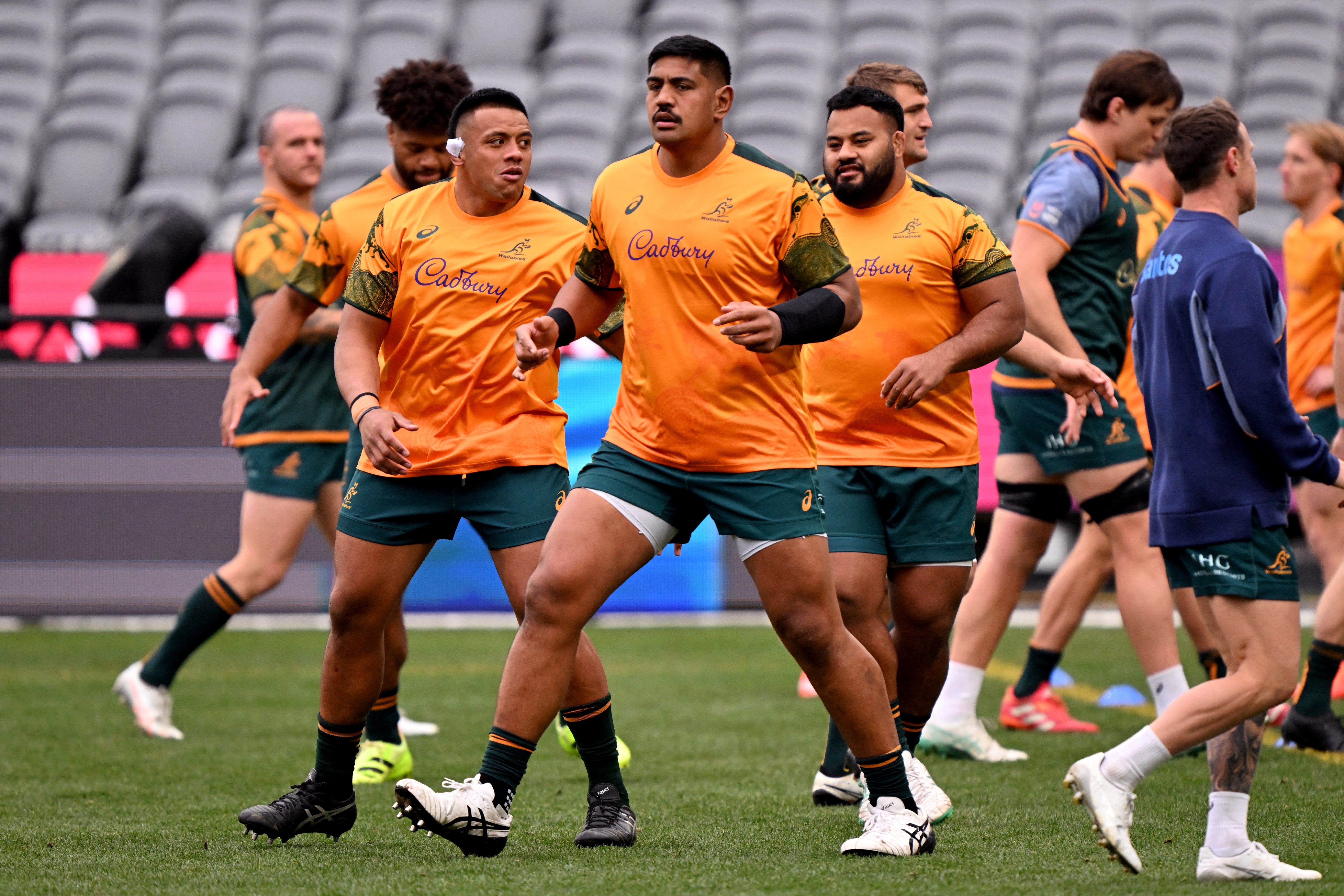 The Australian Wallabies player Will Skelton (C) stretches during the captain's run