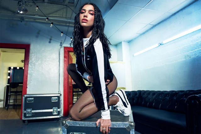 <p>Dua Lipa modelling Puma trainers</p>