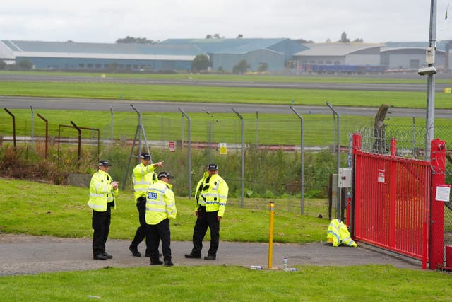 Police outside the perimeter of Prestwick Airport ahead of the arrival of US President Donald Trump (Jane Barlow/PA)