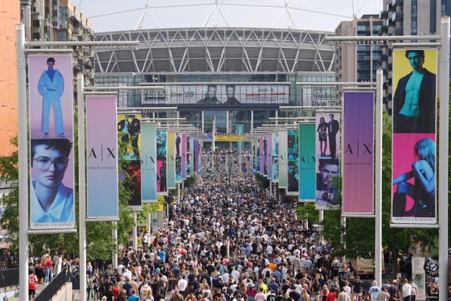 <p>Oasis fans on Wembley Way ahead of the band’s gig </p>