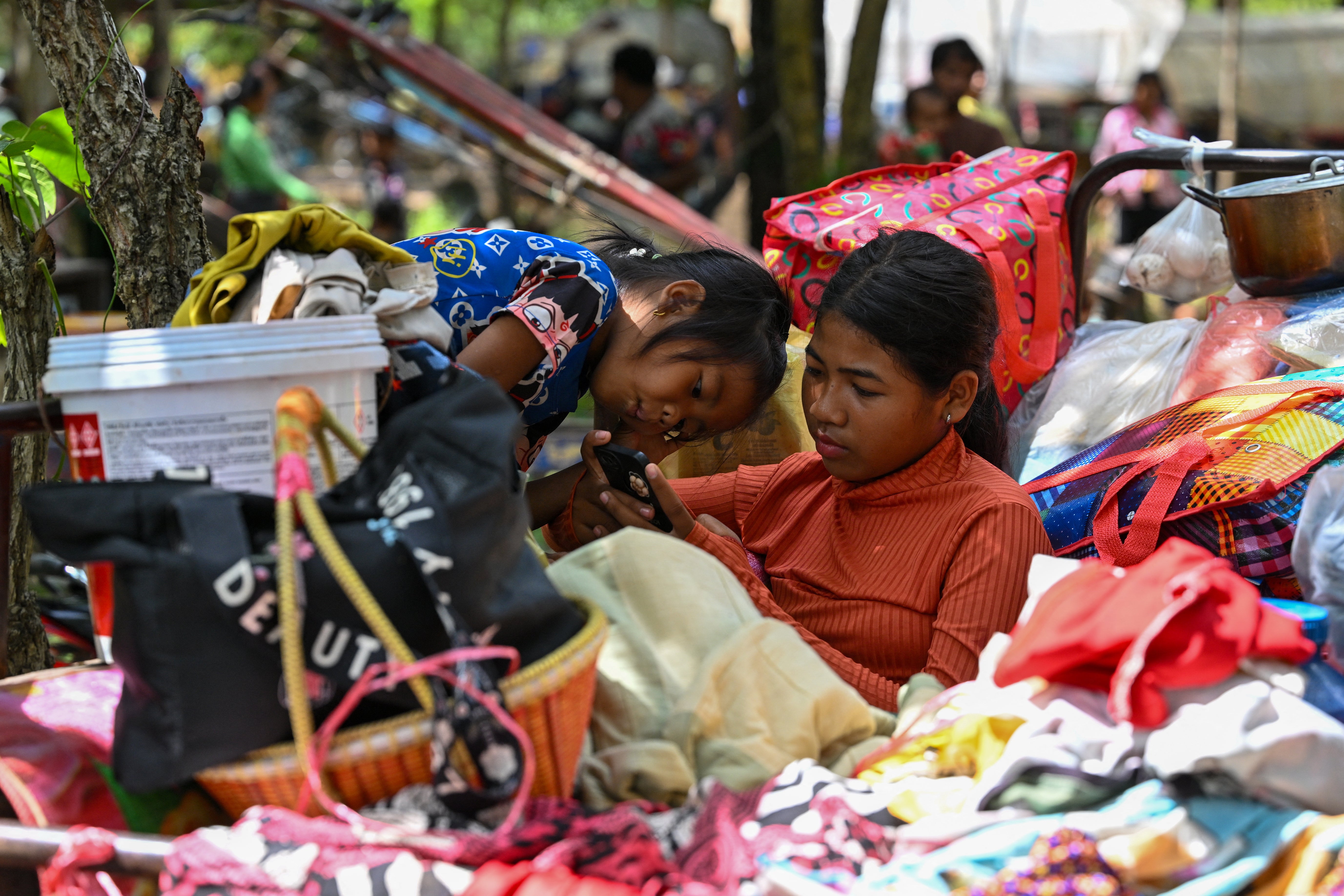 Children fleeing the border conflict between Cambodia and Thailand rest on the grounds of a pagoda in Oddar Meanchey province