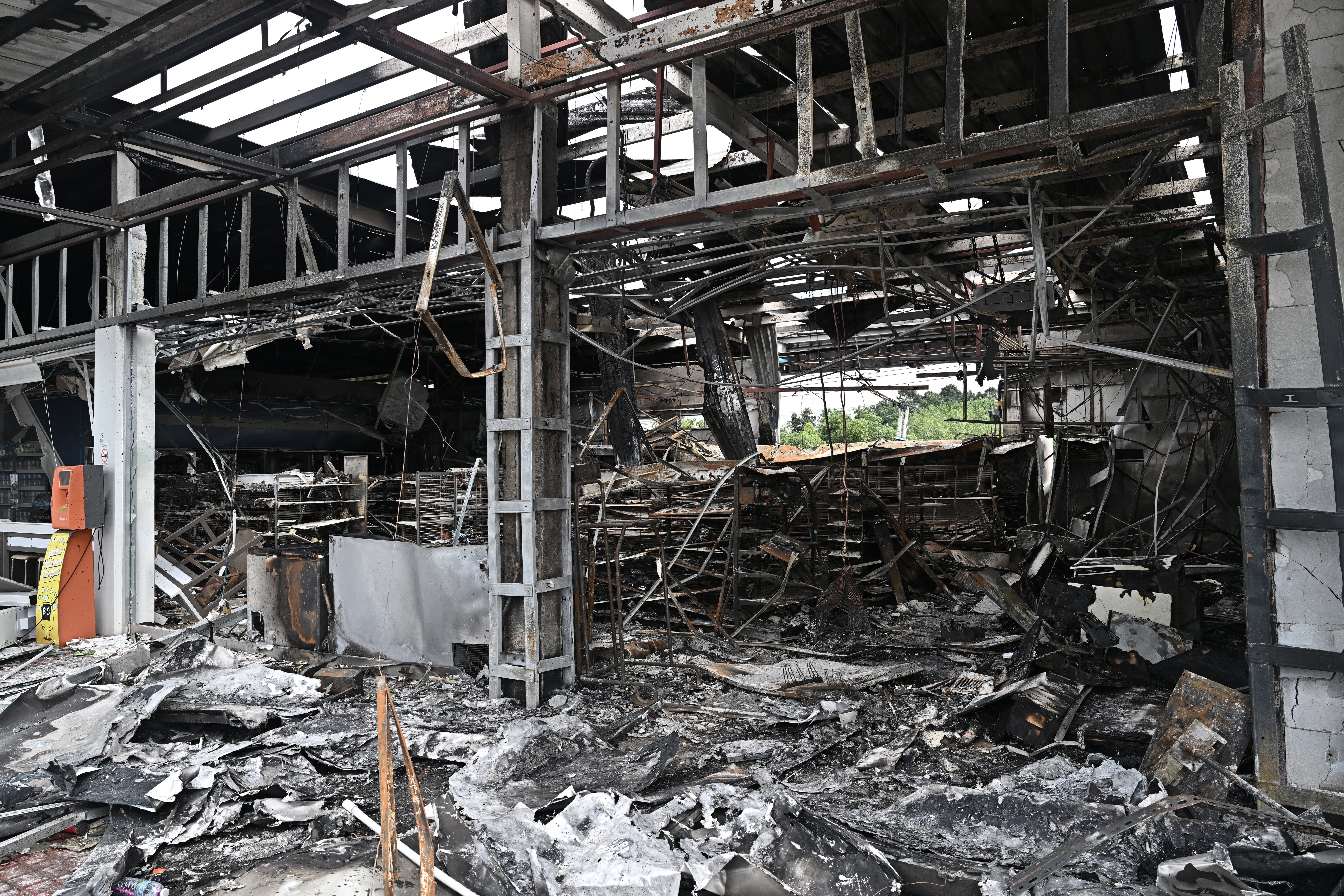 A convenience store at a gas station is left damaged from a fire caused by Cambodian artillery firing in the Thai border province of Sisaket