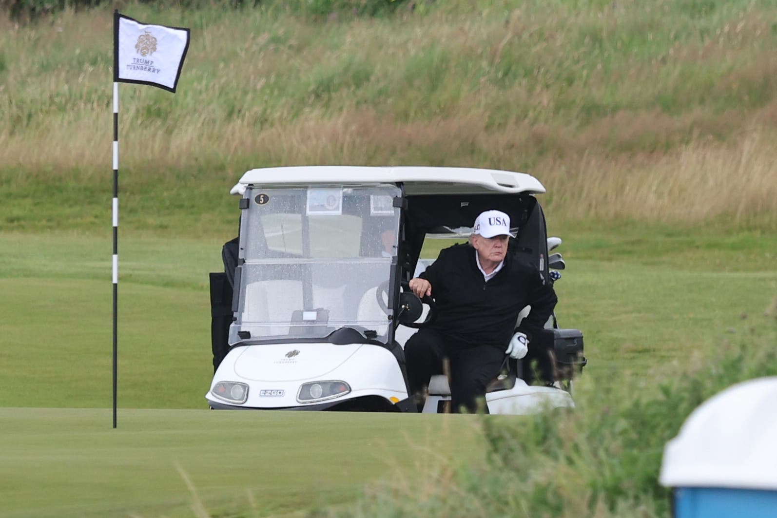 US President Donald Trump in a golf basket on his Trump's Trump Trump in southern Aireshire