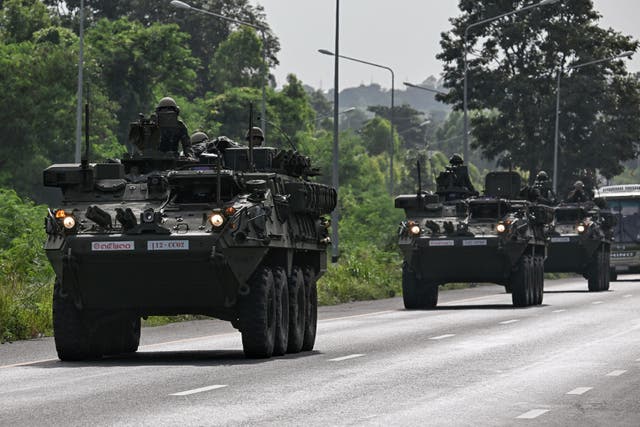 <p>Royal Thai Army soldiers are pictured on armoured vehicles on a road in Chachoengsao province </p>