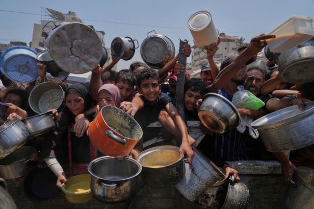 <p>Palestinians struggle to get donated food at a community kitchen, in Gaza City, northern Gaza Strip, Saturday, July 26, 2025</p>