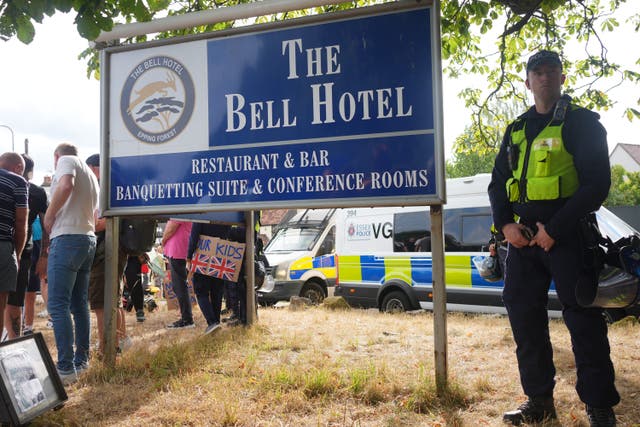 Police outside The Bell Hotel in Epping, Essex, during a protest (Yui Mok/PA)