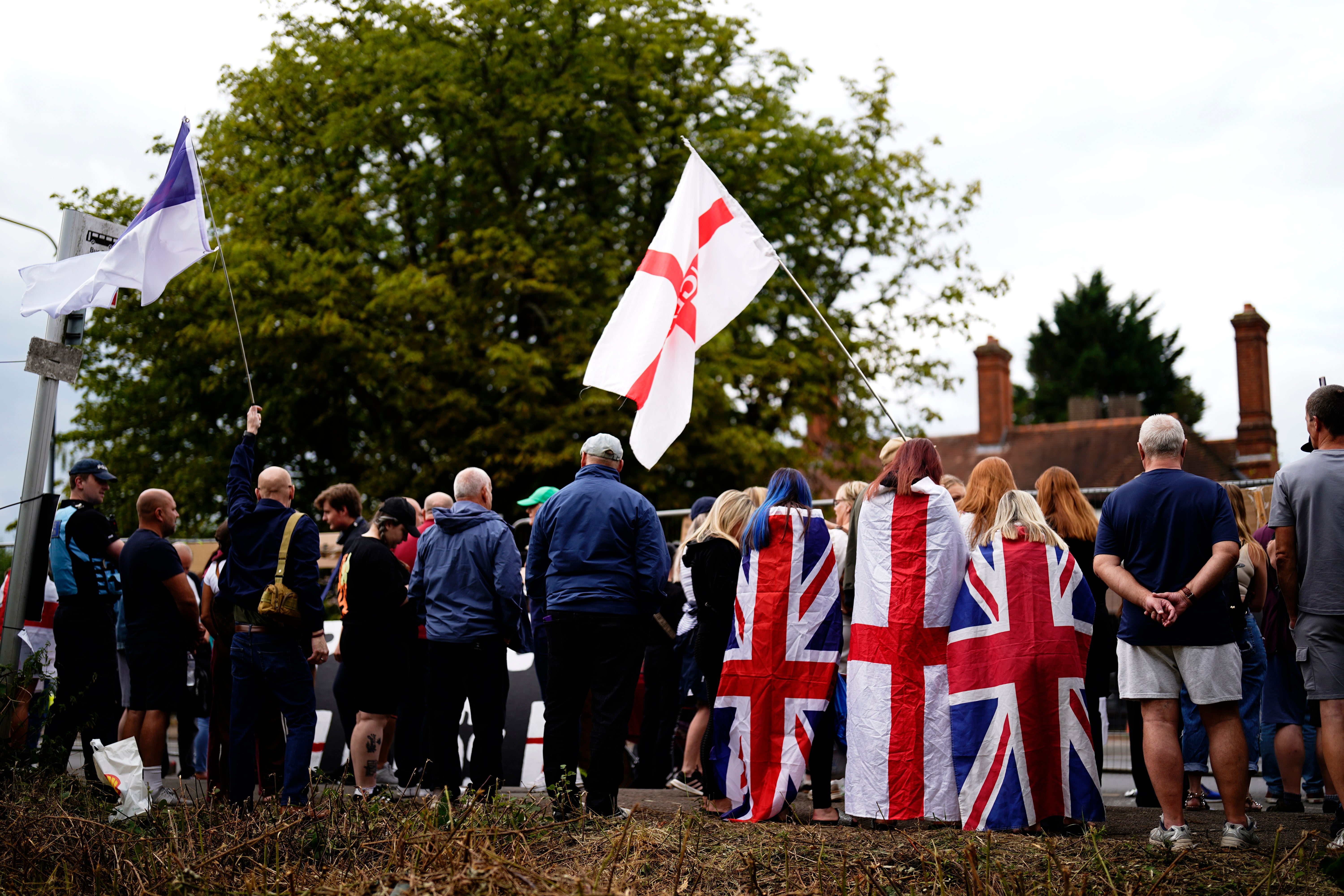 A group of demonstrators, some waving Union flags, gathered near The Bell Hotel