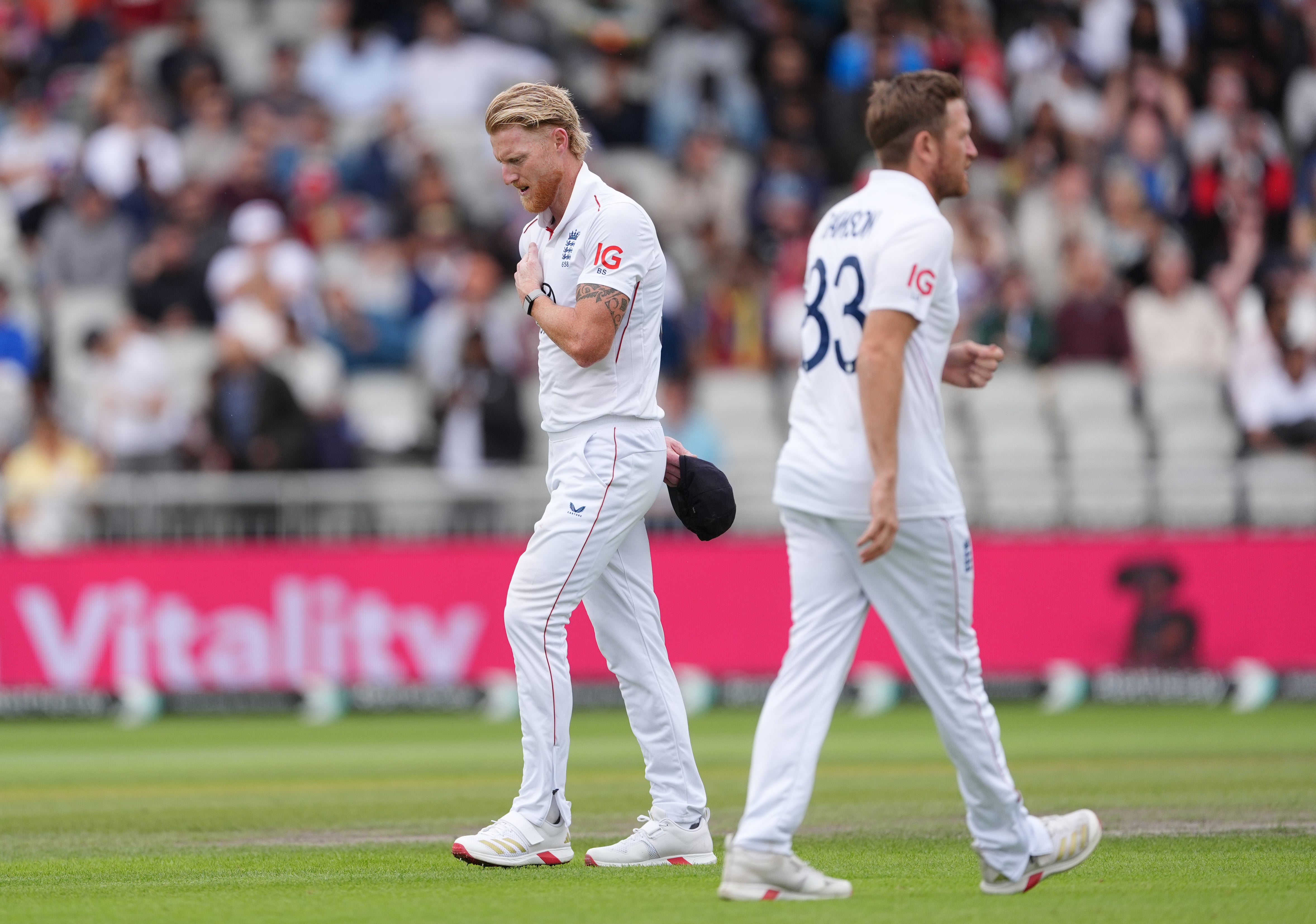 England captain Ben Stokes, left, rubs his shoulder after bowling in Manchester (Martin Ricket//PA)
