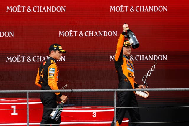 <p>McLaren’s Oscar Piastri, right, celebrates on the podium with his second-placed team-mate Lando Norris (Geert Vanden Wijngaert/AP)</p>