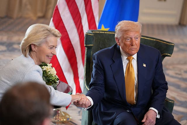 <p>Donald Trump shakes the hand of European Commission president Ursula von der Leyen Sunday. He announced a trade deal had been reached with the European Union later in the day. </p>