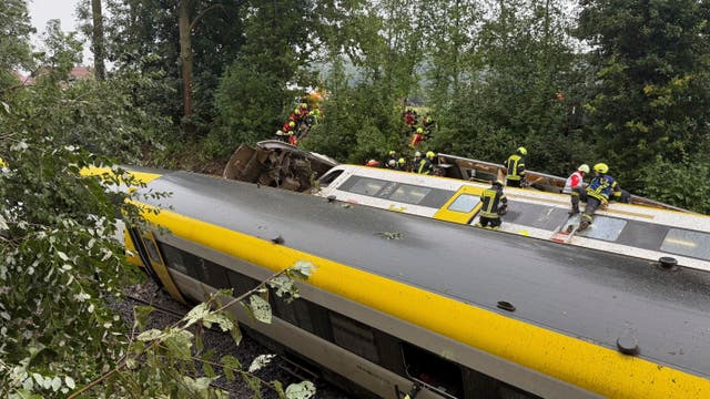 <p>Rescue workers search for passengers in a derailed train, Zwiefaltendorf, Sunday July 27, 2025. (Thomas Warnack/dpa via AP)</p>