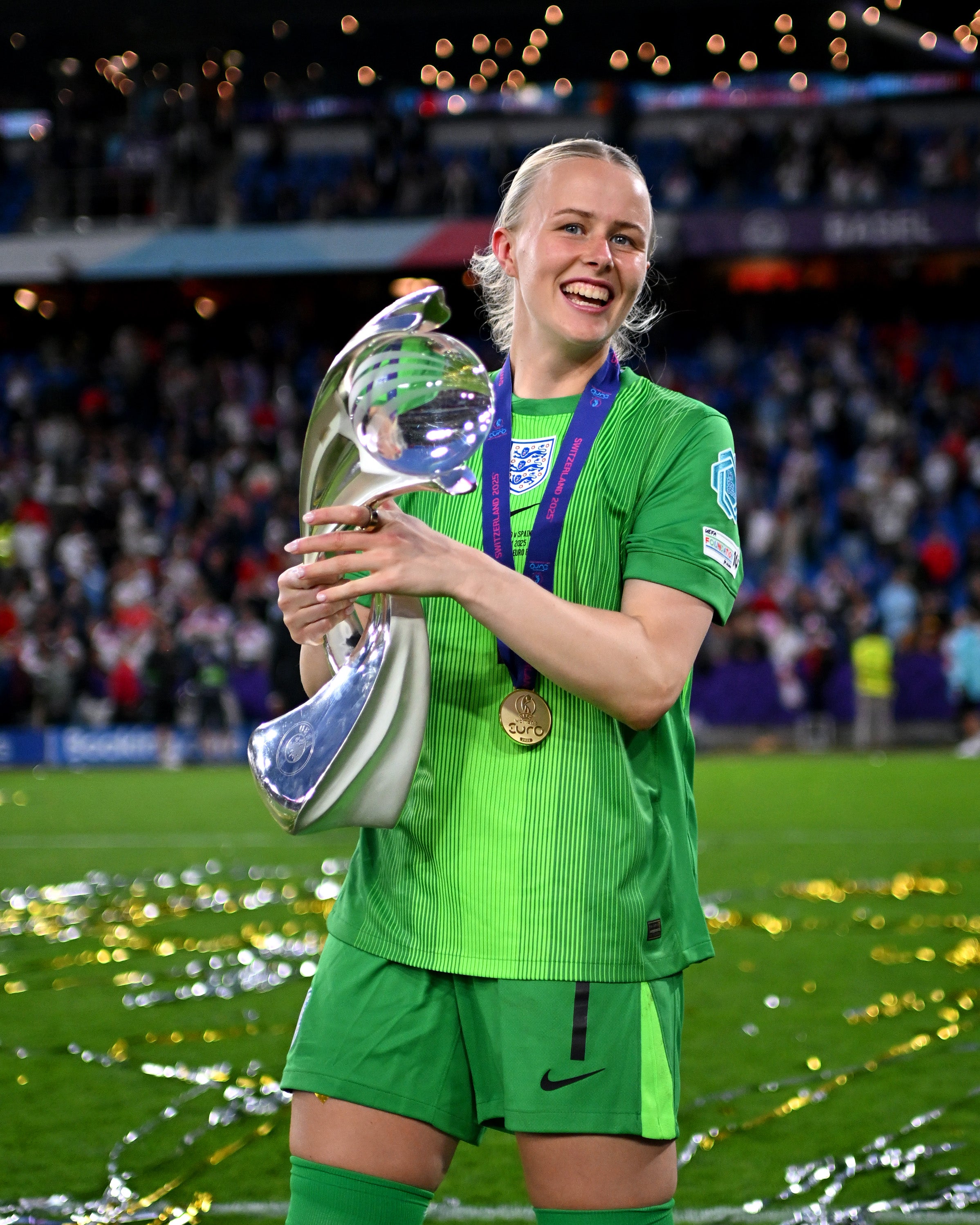 Hannah Hampton of England celebrates with the UEFA Women's EURO trophy