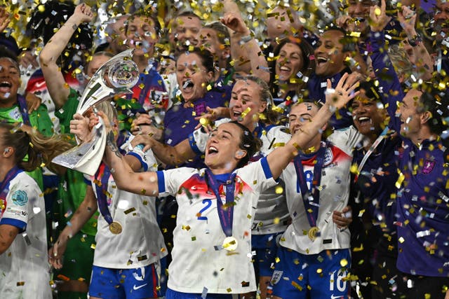 <p>Lucy Bronze lifts the European Championship trophy</p>
