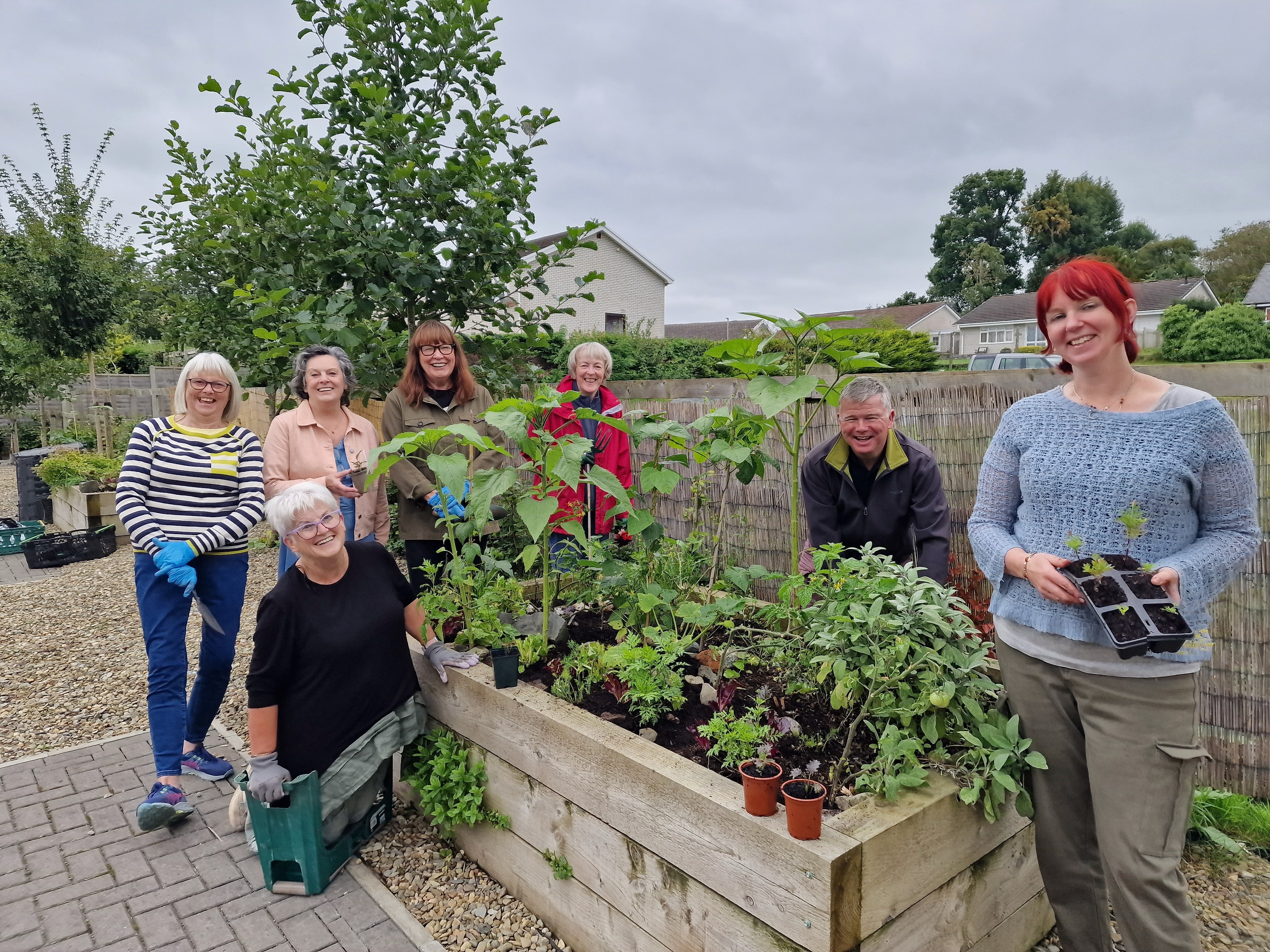 Kim (right) at Creuddyn community garden with other gardeners