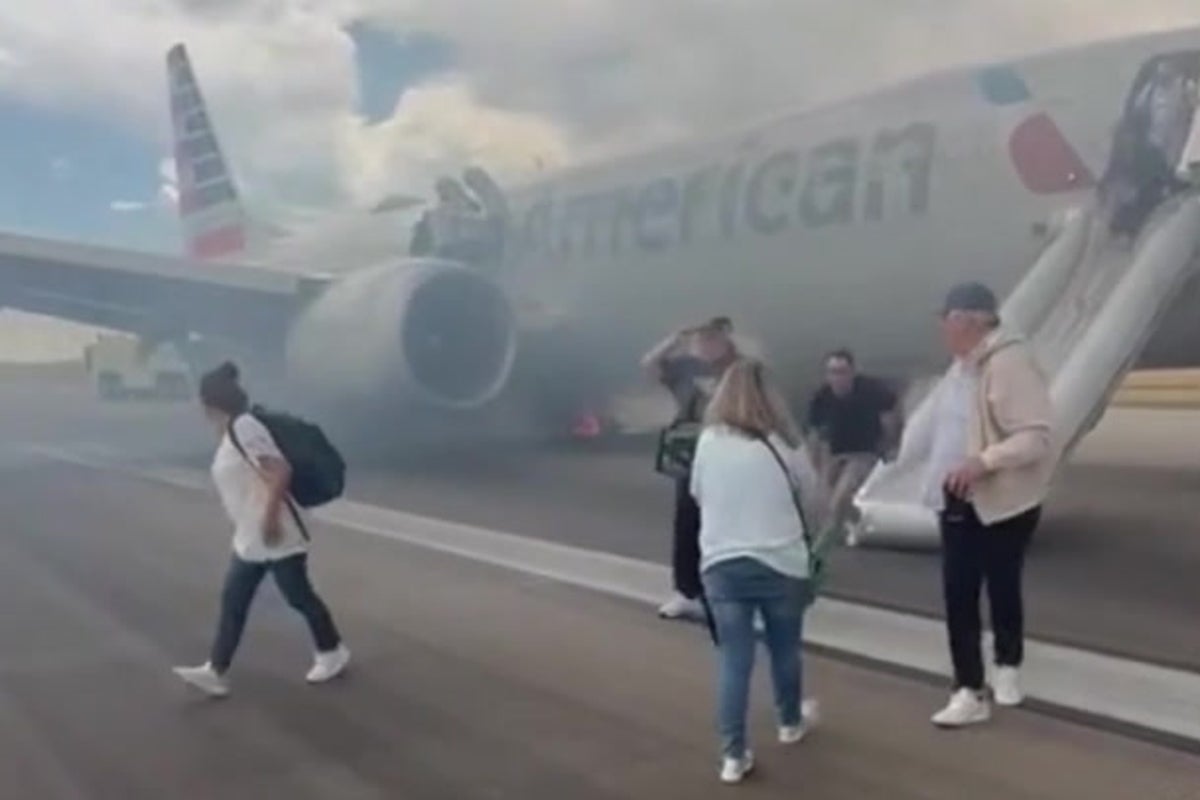American Airlines passengers flee on emergency slide after Boeing plane wheel catches fire