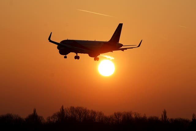 <p>An EasyJet plane lands during sunrise</p>