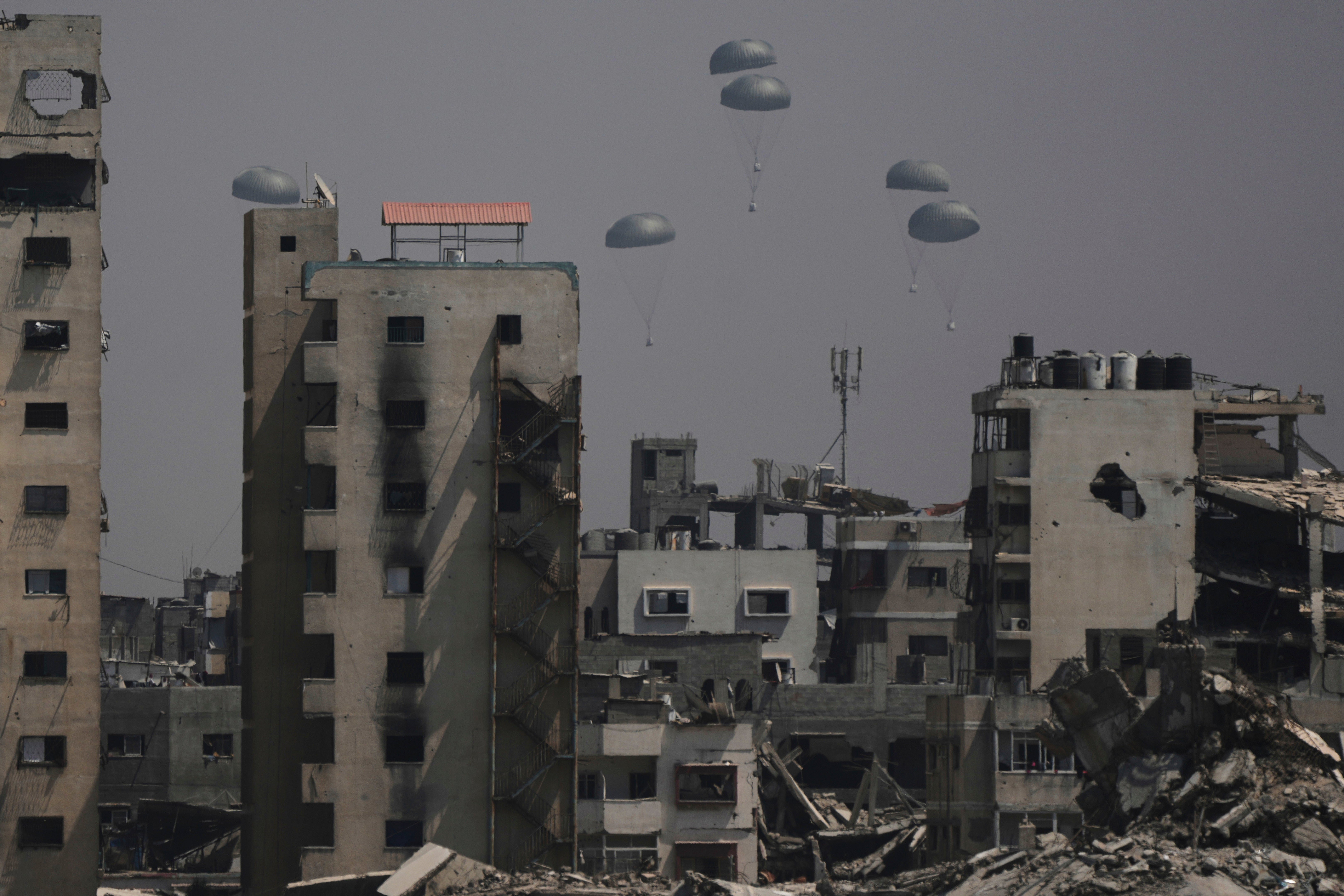 Humanitarian aid is air-dropped to Palestinians over Gaza City