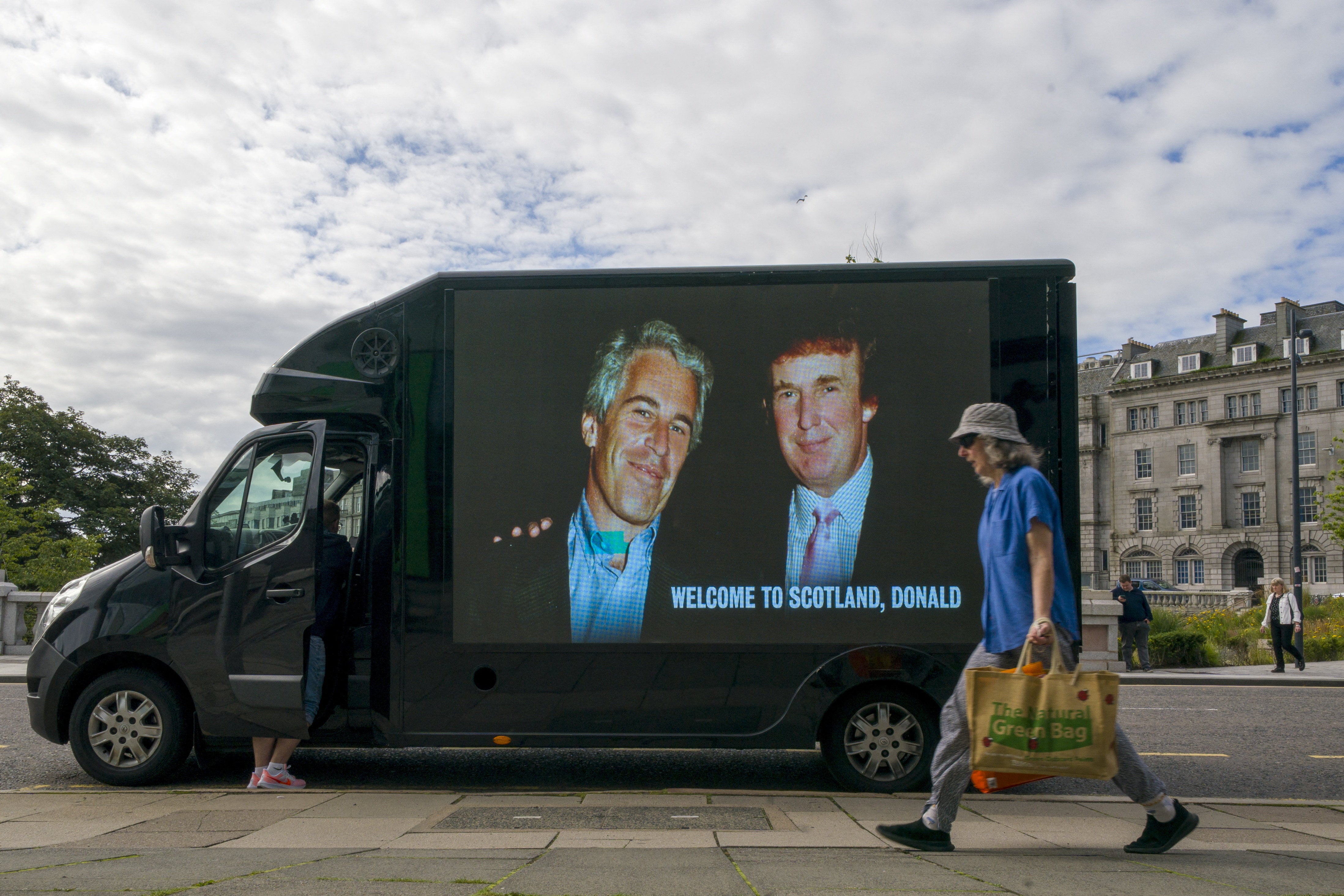 A photograph of President Donald Trump and disgraced financier and sex offender Jeffrey Epstein is displayed on a van during US President Donald Trump's five-day trip to Scotland