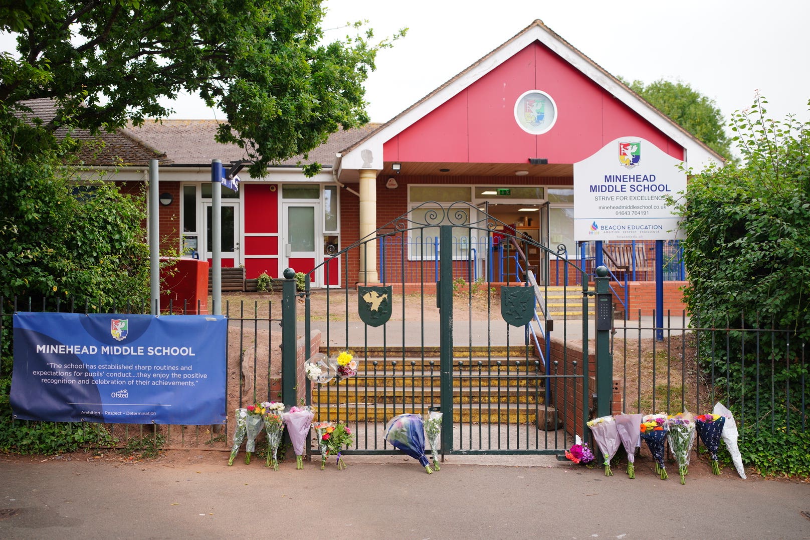 Floral tributes at the entrance to the Minehead Middle School in Somerset (Ben Birchall/PA)